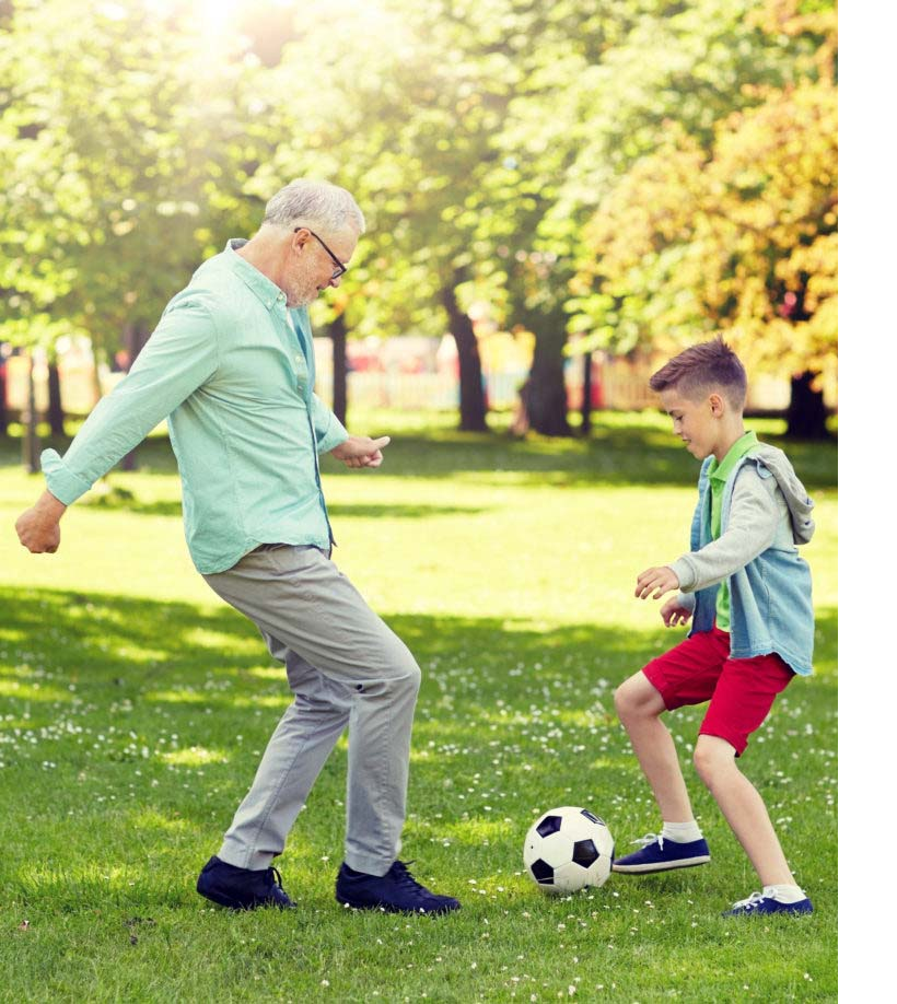 two people playing soccer in park